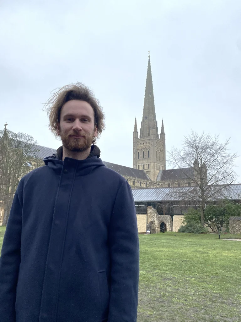 A picture of Douglas Cockburn, the founder of HelloHorizon, standing outside Norwich Cathedral.